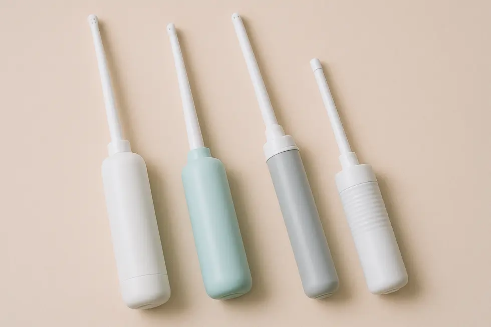 An assortment of portable bidets with different nozzle lengths displayed on a pastel background.